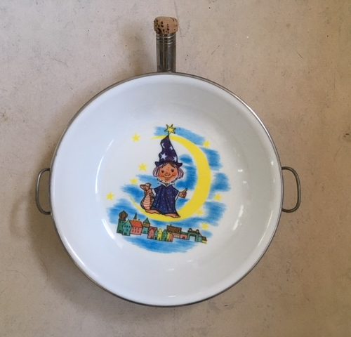 Warmhoud bordje met maanmannetje uit de jaren 1970