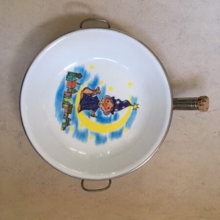 Warmhoud bordje met maanmannetje uit de jaren 1970