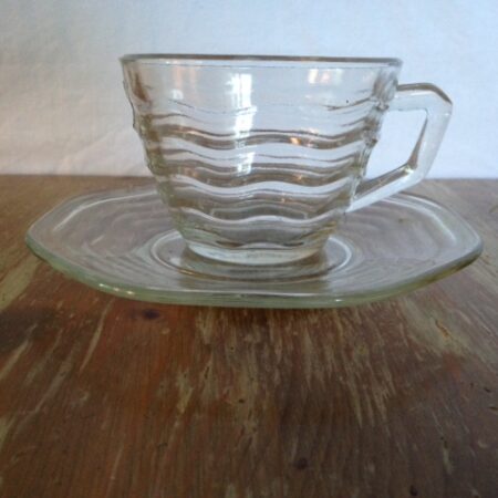 Kop en schotel van helder persglas met golfjes uit de jaren 1940-1950