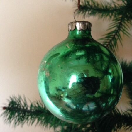Oude kerstbal van dun geblazen glas in gras groen jaren 1970